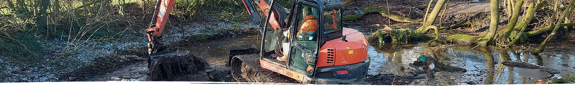 Digger working in pond