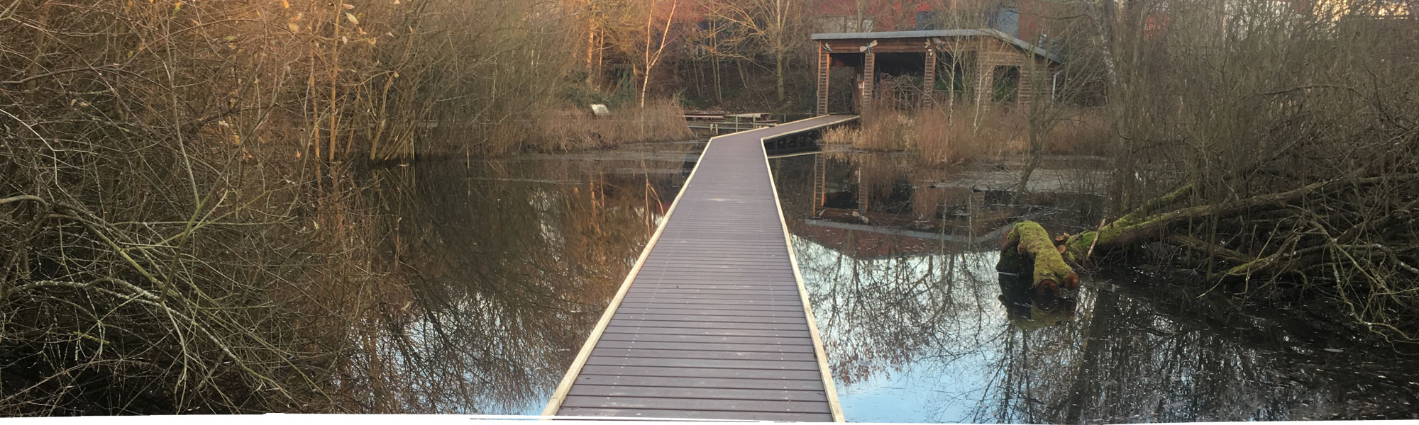 Bridge across pond to conservation hut