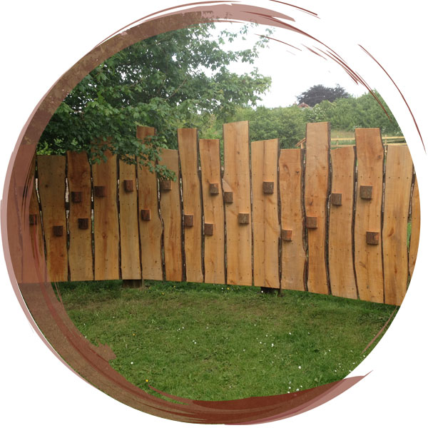 Bird hide screen with viewing windows installed to screen the playground from the new Nature Area at Bronington Sschool, Wrexham