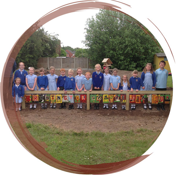 New Nature Area created at Bronington Primary School, Wrexham.  The children created a new sign for the area on wooden boards using hand made paint brushes