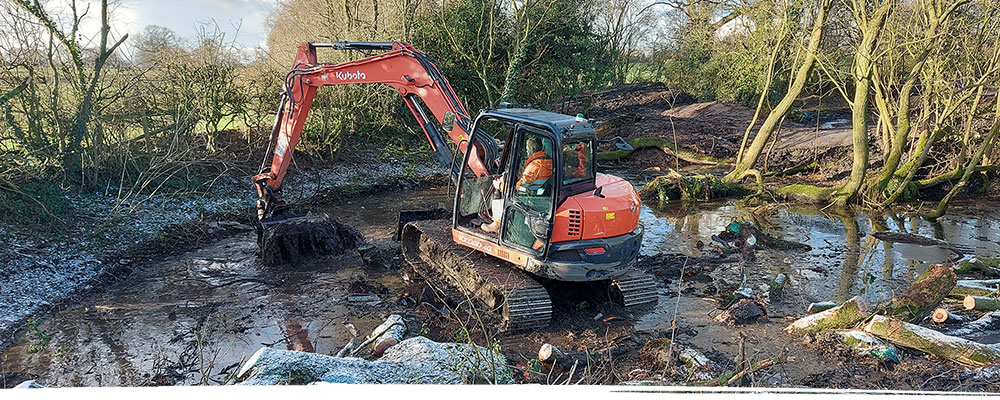 Digger working in pond